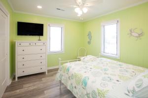 a bedroom with a bed and a flat screen tv at Lazy Day-Z in Virginia Beach