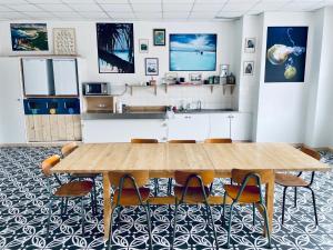 a dining room with a wooden table and chairs at LES BAIGNEURS in Saint-Gilles-Croix-de-Vie +16 photos