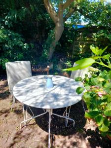 a table and two chairs with a cup on it at Chambres Peyroutas "Amélie" à Vignonet St Emilion in Vignonet