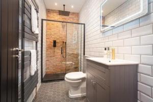 a bathroom with a toilet and a sink and a shower at Capri Stays - Apartment One in Blackpool +9 photos