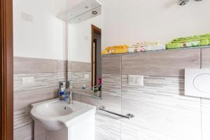 a bathroom with a sink and a toilet and a mirror at Appartamento tra mare e montagna in Gaggi +14 photos