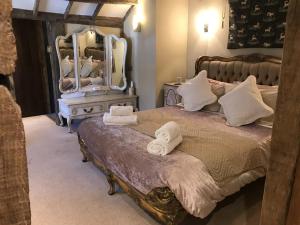 a bedroom with a bed and a dresser at The Chequers Inn in Smarden