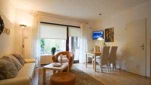a living room with a couch and a table at Haus Wexler 2 - EG in Cuxhaven