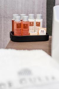 a tray with four bottles of paint on a table at De Gulia Charme and Relax in Castellabate
