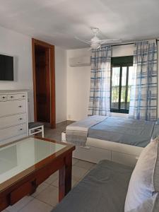 a bedroom with two beds and a table at SERVILUx 2 in Torremolinos