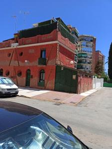 a car parked in front of a red brick building at SERVILUx 2 in Torremolinos