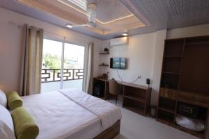 Postel nebo postele na pokoji v ubytování Batuta Maldives Fourson