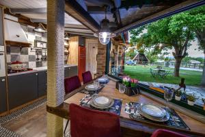 a dining room with a table and a large window at Traditional Guesthouse in Tríkala