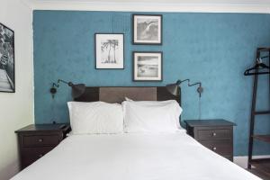 a bedroom with a large bed with a blue wall at Lyme Townhouse in Lyme Regis