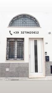 a front door of a building with a sign on it at Casa Le Volte by Ferrocino Holiday in Nardò