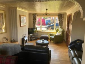 ein Wohnzimmer mit einem Sofa und einem TV in der Unterkunft 3bedroom 1bathroom 1 shower room in quiet area in Inverness
