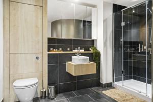 a bathroom with a toilet and a sink and a shower at The Penthouse - By Howburn Residence in Aberdeen
