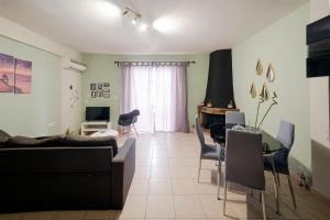 a living room with a couch and a table at Cozy Apartment St John in Chalkida