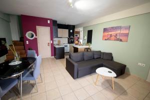 a living room with a couch and a table at Cozy Apartment St John in Chalkida