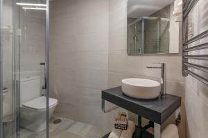 a bathroom with a sink and a toilet at Hostería Miguel Angel in Santillana del Mar +49 photos