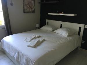 - un lit blanc avec 2 serviettes dans l'établissement Villa Alpilles, à Mouriès