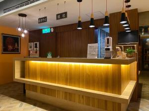 a bar in a restaurant with lights on it at 花鄉商旅 Hua-Xiang Hotel in Kaohsiung