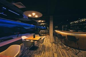 a restaurant with a table and chairs and a bar at Skalny in Szczyrk