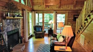 a living room with a fireplace in a log cabin at Mountain Joy in Gatlinburg