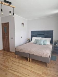 a bedroom with a large bed in a room at Apartament Morski in Gdynia