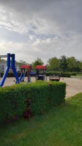 a playground with two play equipment in a park at 'T Groentje Baarland in Baarland