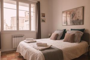 a bedroom with a bed with two towels on it at Chez Pepito & Zaza hypercentre rooftop garage in Nîmes