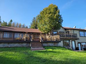 a house with a deck on the side of it at Northumberland Heights Wellness Retreat & Spa in Cobourg