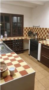 a kitchen with a checkered counter top in a kitchen at Hudace maison partagée in Saint-Laurent du Maroni