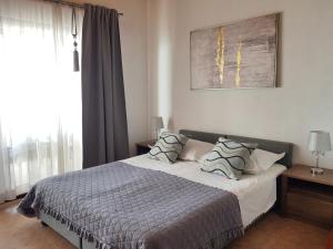 a bedroom with a bed with two pillows on it at Villa Skalinada with sea view in Brela