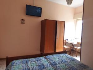 A bed or beds in a room at Alloggio Taddei