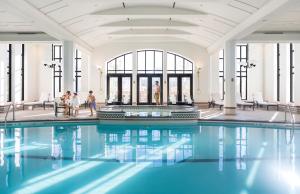 a pool in a building with people walking around it at Fairmont Le Chateau Frontenac in Quebec City