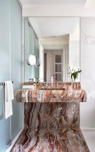 a bathroom with a marble sink and a mirror at Vista Palazzo in Verona
