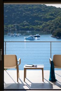 a balcony with a view of the water and boats at Sivota Deamaris Luxury Boutique Hotel in Sivota