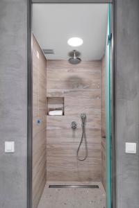 a shower with wooden walls and a shower head at Sivota Deamaris Luxury Boutique Hotel in Syvota