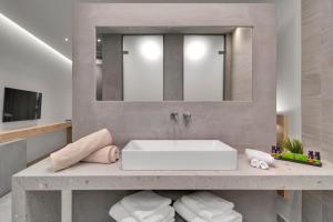 a bathroom with a sink and a mirror at Sivota Deamaris Luxury Boutique Hotel in Syvota