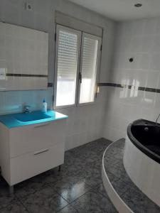 a bathroom with a sink and a toilet and a mirror at Apartamento Duartes en Barbastro vistas al pirineo in Barbastro