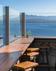 a wooden table with benches and a view of the ocean at Tangoinn Hostel Downtown in San Carlos de Bariloche