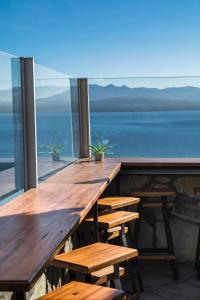 a row of tables in a restaurant with a view of the ocean at Tangoinn Hostel Downtown in San Carlos de Bariloche