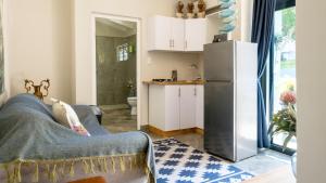 a kitchen and a living room with a refrigerator at At The Sea Ballito in Ballito