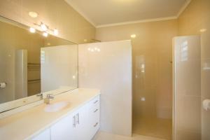 une salle de bain blanche avec lavabo et douche dans l'établissement Attractive villa in resort, à Willemstad 22 autres photos