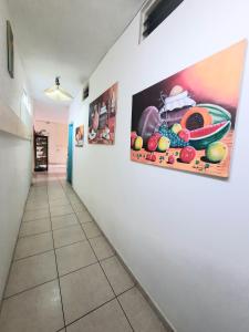 a hallway with paintings on the wall at San Gil Tours Hostal in San Gil