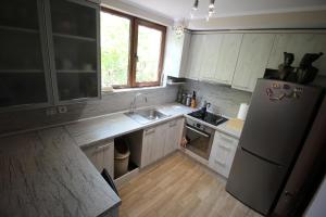 an empty kitchen with a refrigerator and a sink at Izgrev Sarafovo in Burgas City