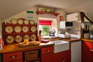 a kitchen with a counter top with a sink and a counter sidx sidx at Finest Retreats - Woodend - The Bothy in Ulpha