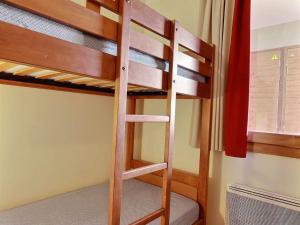 a bunk bed with a ladder in a room at Appartement 3 pièces avec balcon et 2 salles de bains, 6 personnes, Plagne Soleil - FR-1-455-48 in Plagne Villages