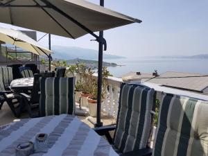 a table and chairs with a view of the ocean at Apartments Panorama in Senj