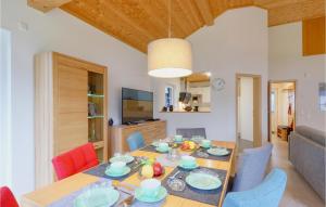 a dining room and living room with a table and chairs at Ferienhaus 28 Altefähr in Altefähr