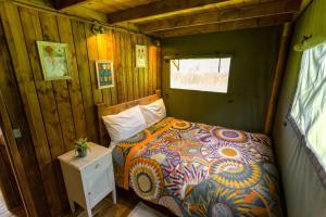 um quarto com uma cama num pequeno quarto em Awe Inspiring two storey tent em Crowhurst