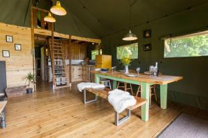 a room with a table and chairs in a tent at Awe Inspiring two storey tent in Crowhurst