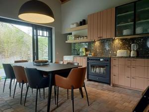 a kitchen with a dining room table and chairs at Mademoiselle Nineth met sauna in De Panne