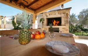 a wooden table with fruit on it with a fireplace at Amazing Home In Brodarica With Kitchen in Brodarica
